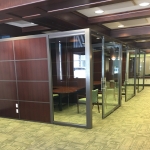 View Series glass office fronts with Flex Series laminate sidewalls brownstone frame finish #1715